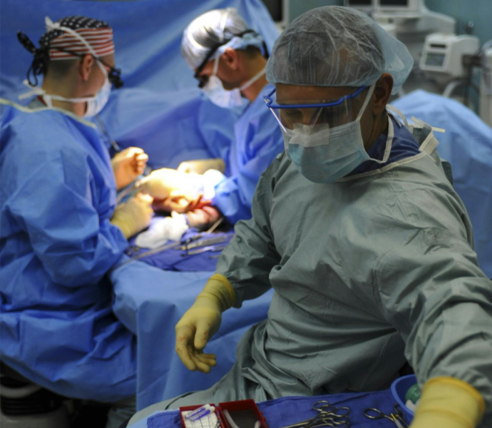 Surgeon reaching for gauze in operating room setting